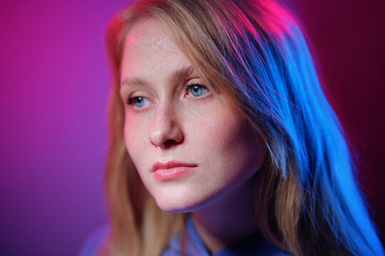 Colorful close-up studio portrait of a young woman