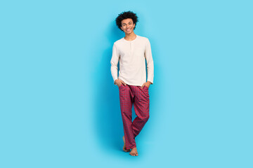 Full size photo of cute young guy posing hands pockets shopping wear trendy white pajama outfit...