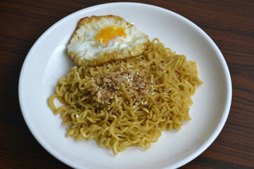 close up plate of noodle with egg and chopstick, isolated on textured background