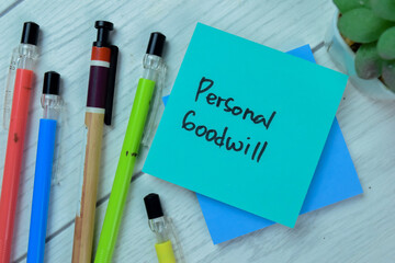 Concept of Personal Goodwill write on sticky notes isolated on Wooden Table.