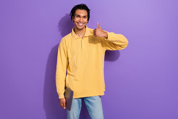 Photo of intelligent handsome person with cornrows wear stylish shirt showing thumb up hold laptop isolated on purple color background