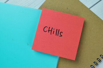 Concept of Chills write on sticky notes isolated on Wooden Table.