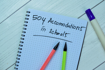 Concept of 504 Accomodations in Schools write on book isolated on Wooden Table.