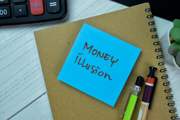 Concept of Money Illusion write on sticky notes isolated on Wooden Table.