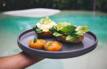 Unrecognizable person with plate of healthy breakfast