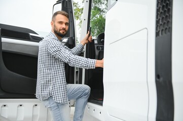 Truck driver climbing into cab of semi-truck