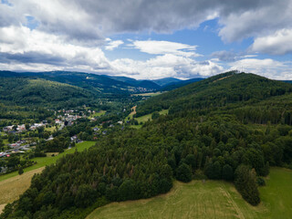 Obraz premium Landscape of Jeseniky mountains with village in valley. Czech republic