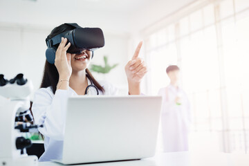 Student using VR glasses headset technology for help visual learning education science class room in modern school