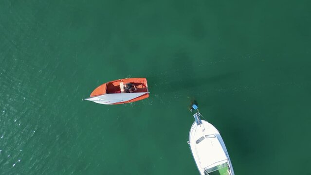 Man In Sailboat Cruising Across Bahia de Aldan In Pontevedra, Spain. aerial topdown