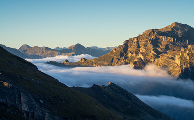 Fototapeta na wymiar Clouds in the valleys of the Italian alps during a tranquil dawn.