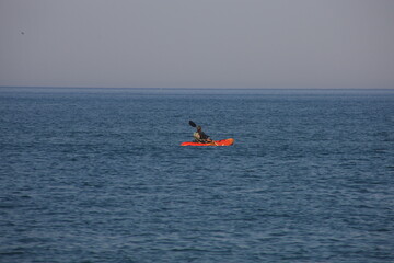 Man sails his kayak on the Atlantic Ocean
