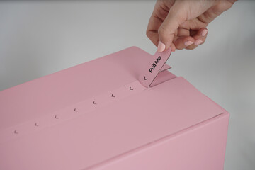 A pink packaging delivery or shipping box with hands opening the package or the box. cardboard pink...
