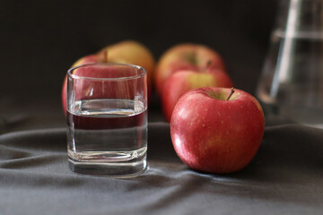 still life, a glass of water and ripe apples