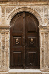 Old ancient colourful textured door in a stone wall in Greece, Crete. Vintage doorway. Traditional European, Greek architecture. Summer travel