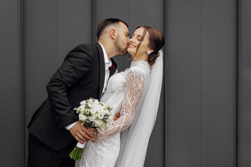 the groom tenderly kisses the bride. Young wedding couple on their wedding