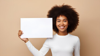 Happy young woman holding blank white banner sign, Beautiful african american girl showing white board over beige wall background