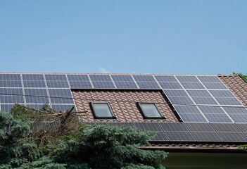 Installing a Solar Cell on a Roof. Solar panels on roof. Historic farm house with modern solar panels on roof and wall. High quality photo