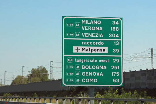 road sign with the names of important Italian cities and directions to the MALPENSA airport in Milan