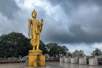 Golden standing Big Buddha statue on a square under cloudy sky, Koh Samui, Thailand