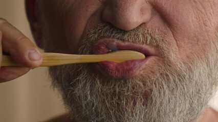 Close up unrecognizable old male retired middle-aged senior mature elderly man cropped view mouth brushing teeth toothbrush and toothpaste morning hygiene procedure oral anti cavity tooth care dental