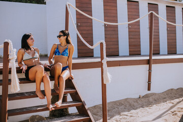 Smiling young women in bikini enjoying vacation on the beach