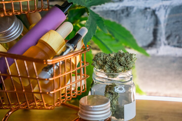 Mini shopping cart with various Medical Cannabis products on table, Shopping purchase concept of...
