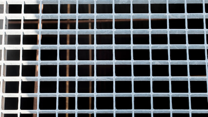 Texture of empty metal squares on a black background