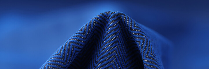 Element of blue fabric with zigzag pattern.