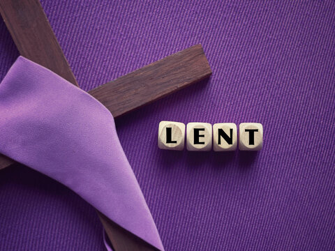 Christianity concept about Good Friday, Lent Season and Holy Week. LENT written on wooden blocks. With blurred purple background.