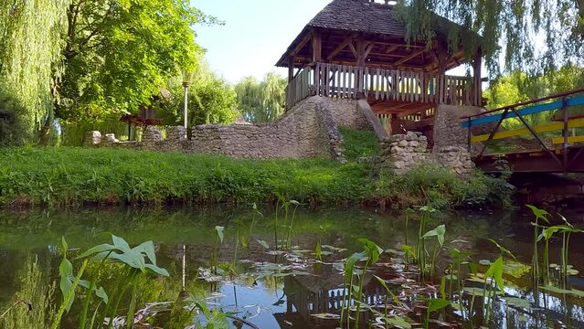 Fresh green view of Seret river with wooden fortress on the shore. Splendid morning scene of Topilche Park in Ternopil city, Ukraine, Europe. 4K video (Ultra High Definition).