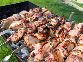 Juicy kebab is fried on skewers on the grill