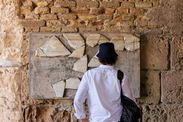 Person contemplating old scripture