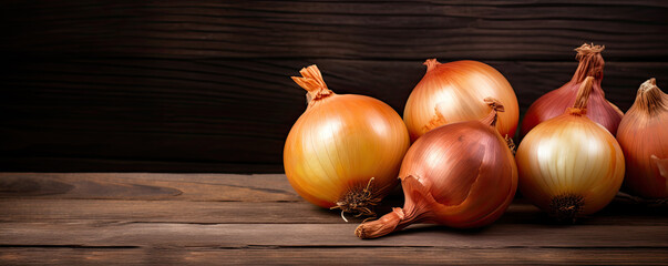 Onions on wooden board. Fresh onion against old wood table.  copy space for text - obrazy, fototapety, plakaty