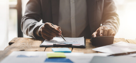 Portrait of a male businessman working using a tablet computer in a modern office. Prepare account analysis reports Real estate investment information Financial and tax system concepts