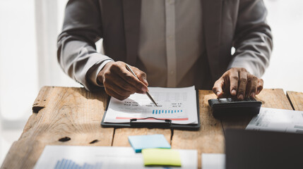 Portrait of a male businessman working using a tablet computer in a modern office. Prepare account analysis reports Real estate investment information Financial and tax system concepts