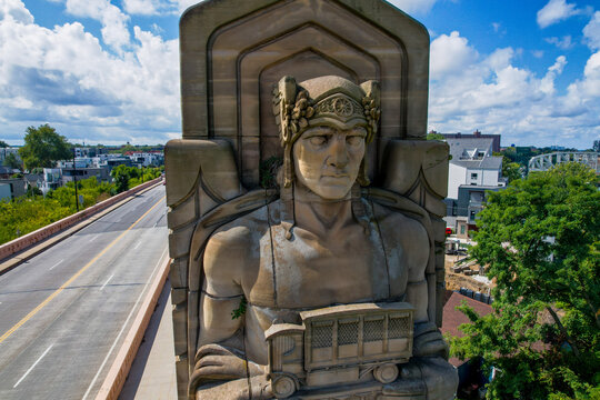 One of Cleveland's Art Deco "Guardians of Traffic" statues on top of Hope Memorial Bridge, which is sprouting a small tree on its shoulder