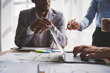 Young colleagues discussing business and price chart analyzes business people on the table great in...