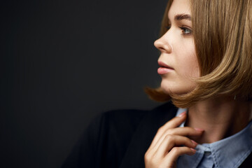 elegant blonde business woman on black background