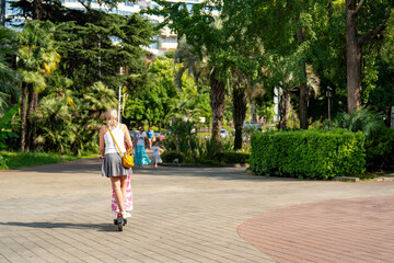 Girl and child on the same scooter