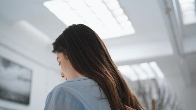 Thoughtful girl visit gallery closeup. Beautiful woman enjoying contemporary art