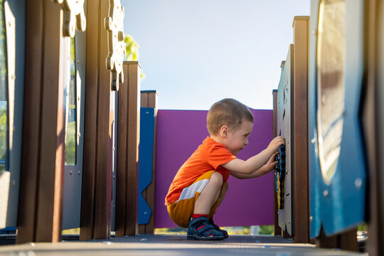 Cute toddler boy two or three years old is playing on the playground outside. Healthy summer activity for children. Children's games. Selective focus