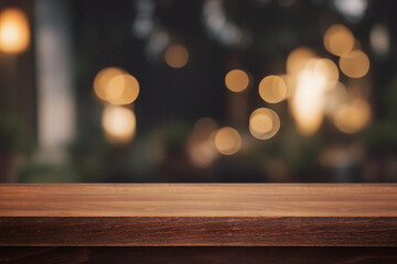 Beautiful natural wooden table with light lamp bokeh background