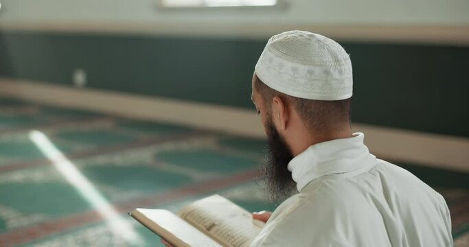 Islamic man, kiss quran and mosque for faith, reading or mindfulness with worship, praise or back for study. Muslim person, religion and peace in book, prayer or learning holy scripture in Palestine