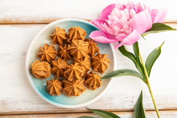 Homemade soft caramel fudge candies on white wooden, top view