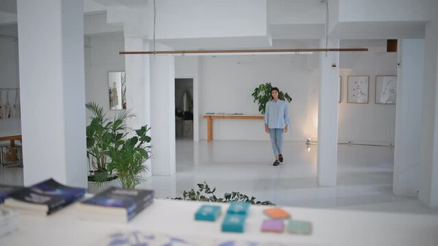 Girl going modern office space. Beautiful woman visit art gallery on weekend.