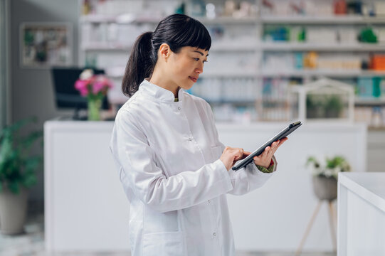 Japanese health worker is standing in a pharmacy