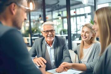 Mature employees and younger employees discussing work issues at the table, people working together