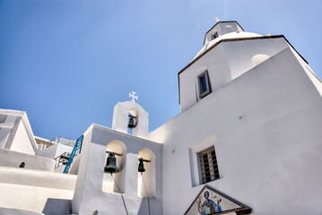 Fototapeta na wymiar Fira, Greece - July 20, 2023: The architectural dome of the Saint Minas Holy Orthodox Church in Fira, Santorini, Greece 