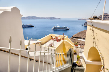 Fira, Greece - July 20, 2023: Views of cruise ships and the rocky landscapes from Fira on the island of Santorini in Greece
 - obrazy, fototapety, plakaty