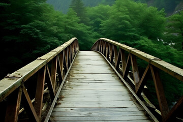 Obraz premium Beautiful wooden bridge over the river in the mountains nature view.